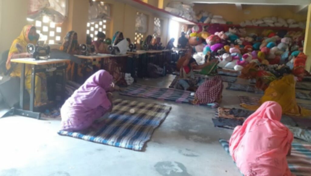 Women making mattress or Sujani of old clothes in Sujani Center, Bihar