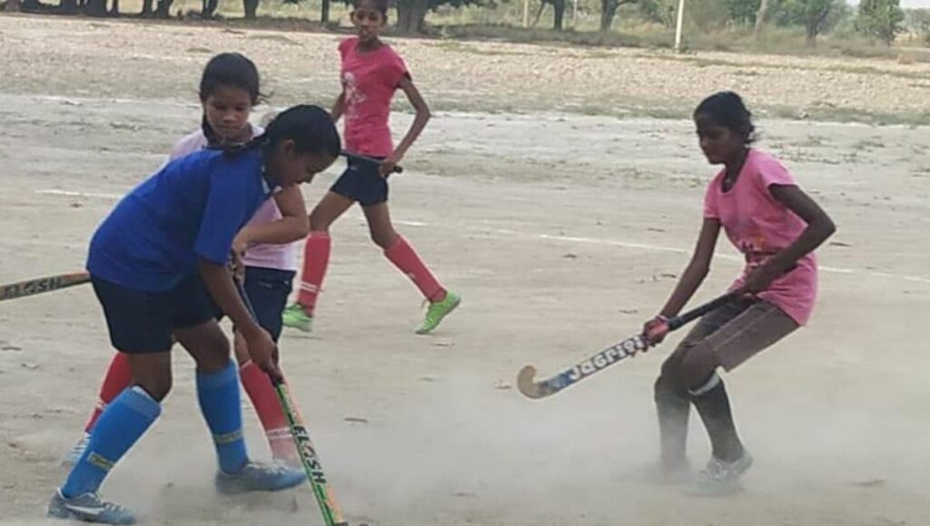 Girls playing Hockey in Mary Kom Sports Academy 