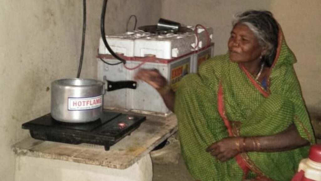 woman cooking on solar induction in Bancha Village