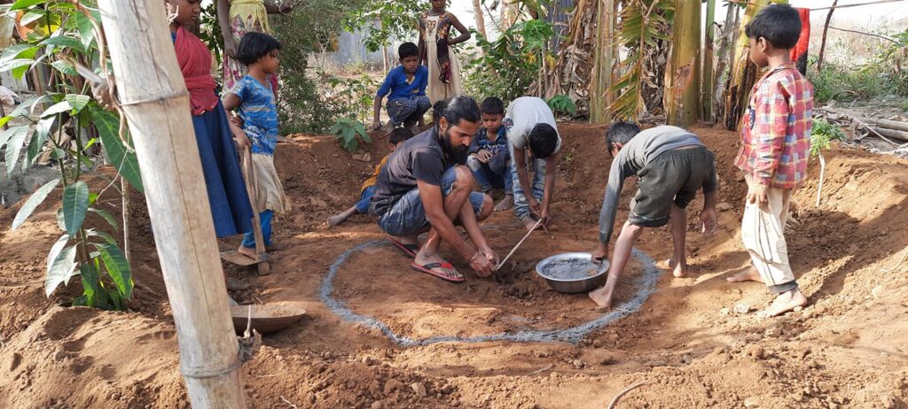 Dharmendra making pond with children