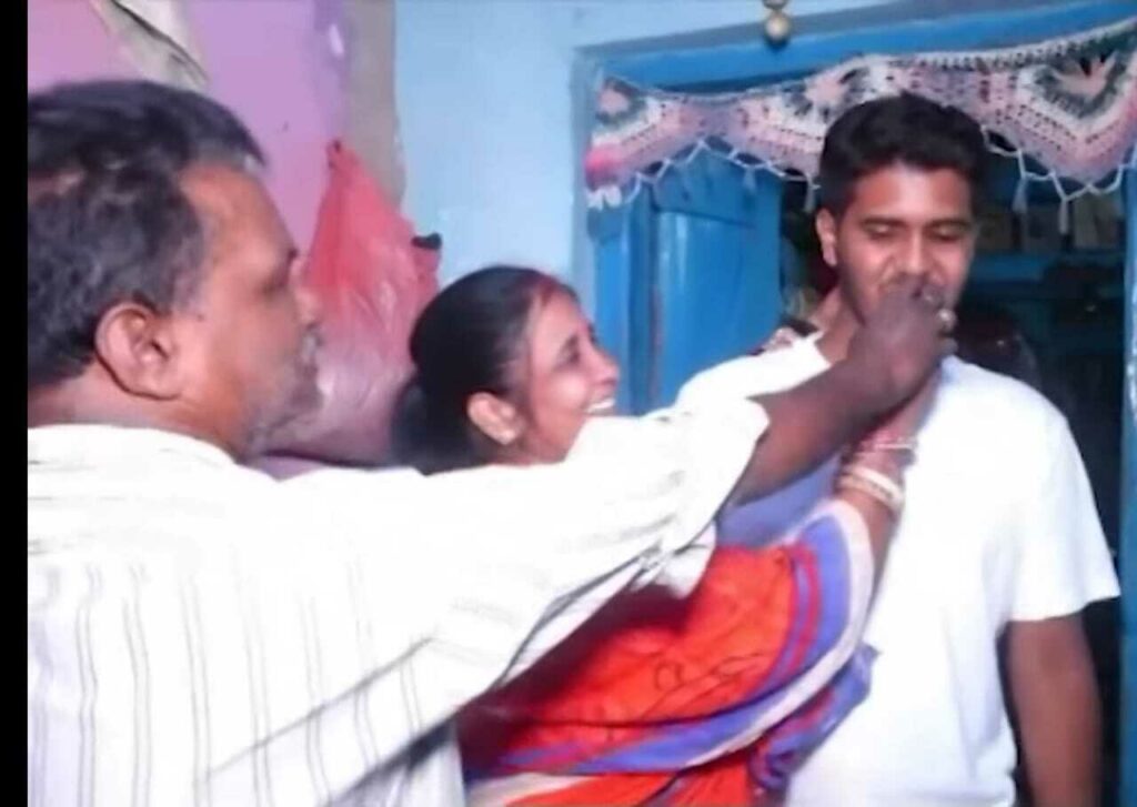 Suraj celebrating with parents.
