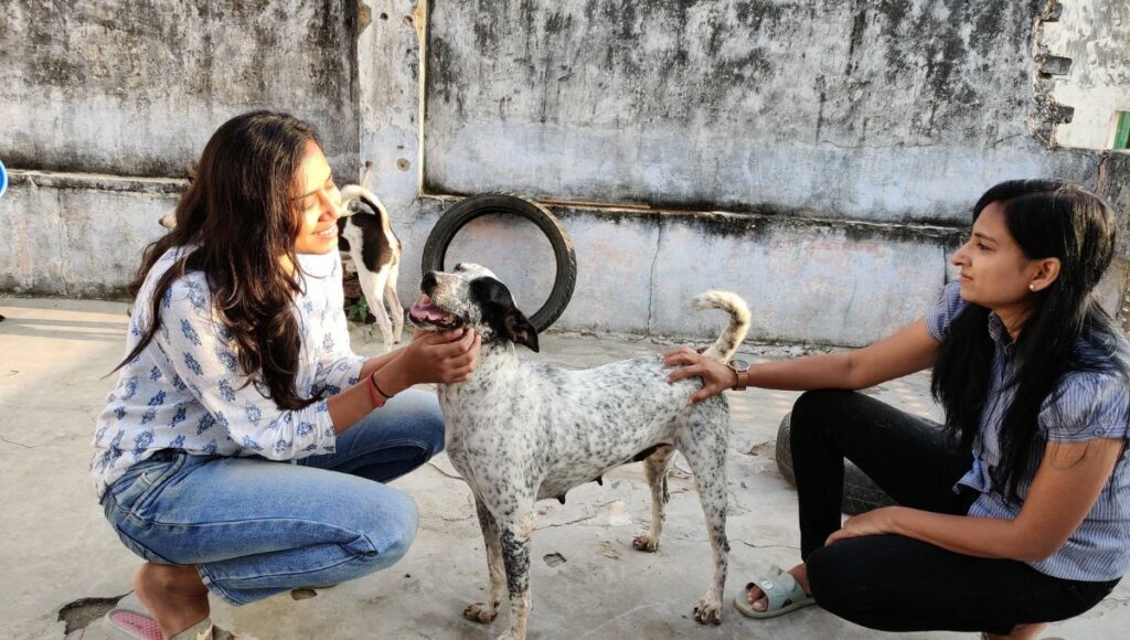 Sonal with her friend and a dog 