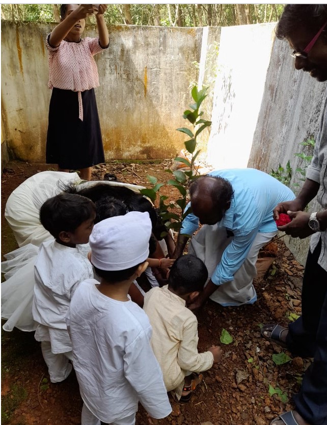 C C Kannan doing plantation with students  